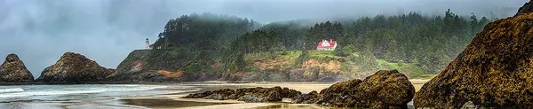 Stormy day panorama of Heceta Head Beach with the lighthouse and keepers' home.