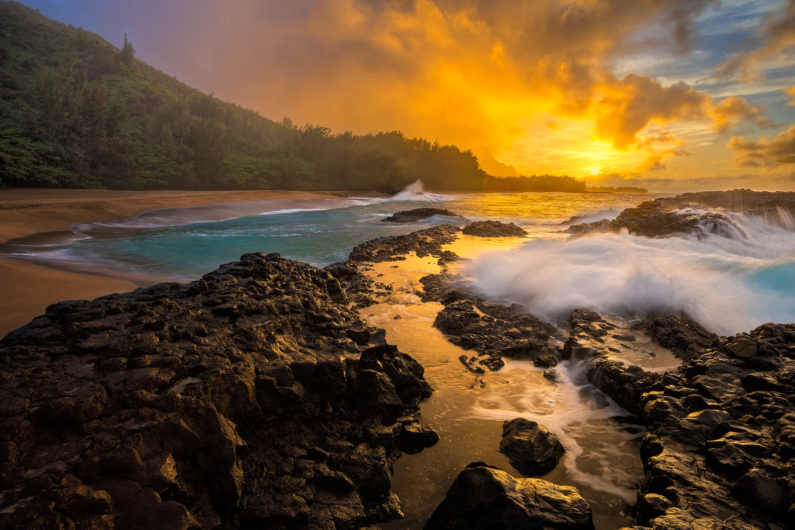 Lumahai Beach sunset photo, Kauai: volcanic rock, sunset cloud reflections, smooth wave. Landscape photography by Andy Cook.