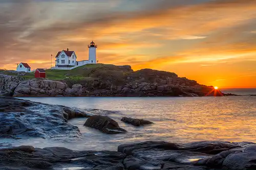 Sunrise photograph of the Nubble Lighthouse on the Maine Coast.