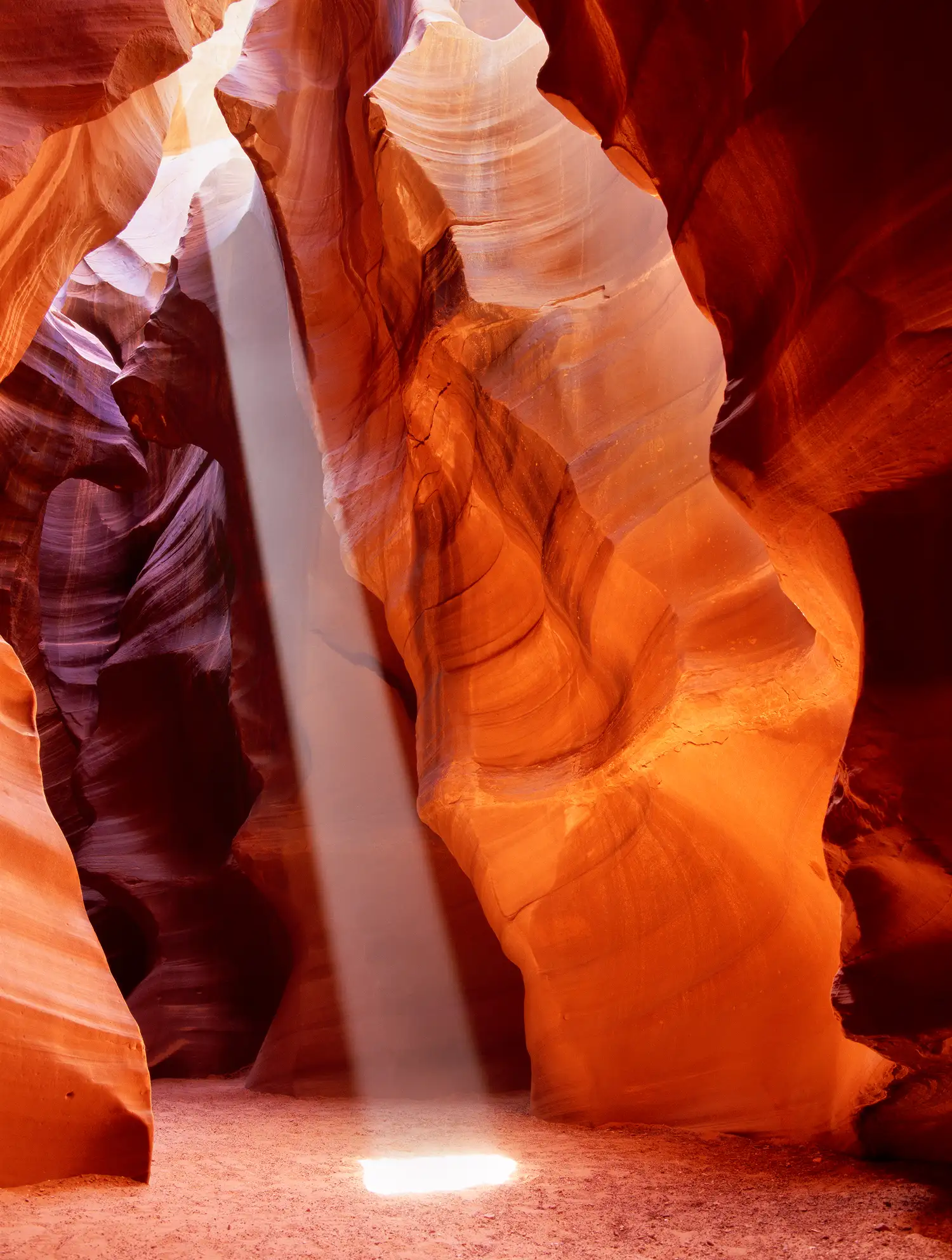 A sunlight beam illuminating the sculpted walls of Upper Antelope Canyon, Arizona.