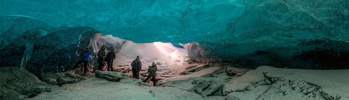 Photographers in a blue ice cave, Iceland. Workshop setting.