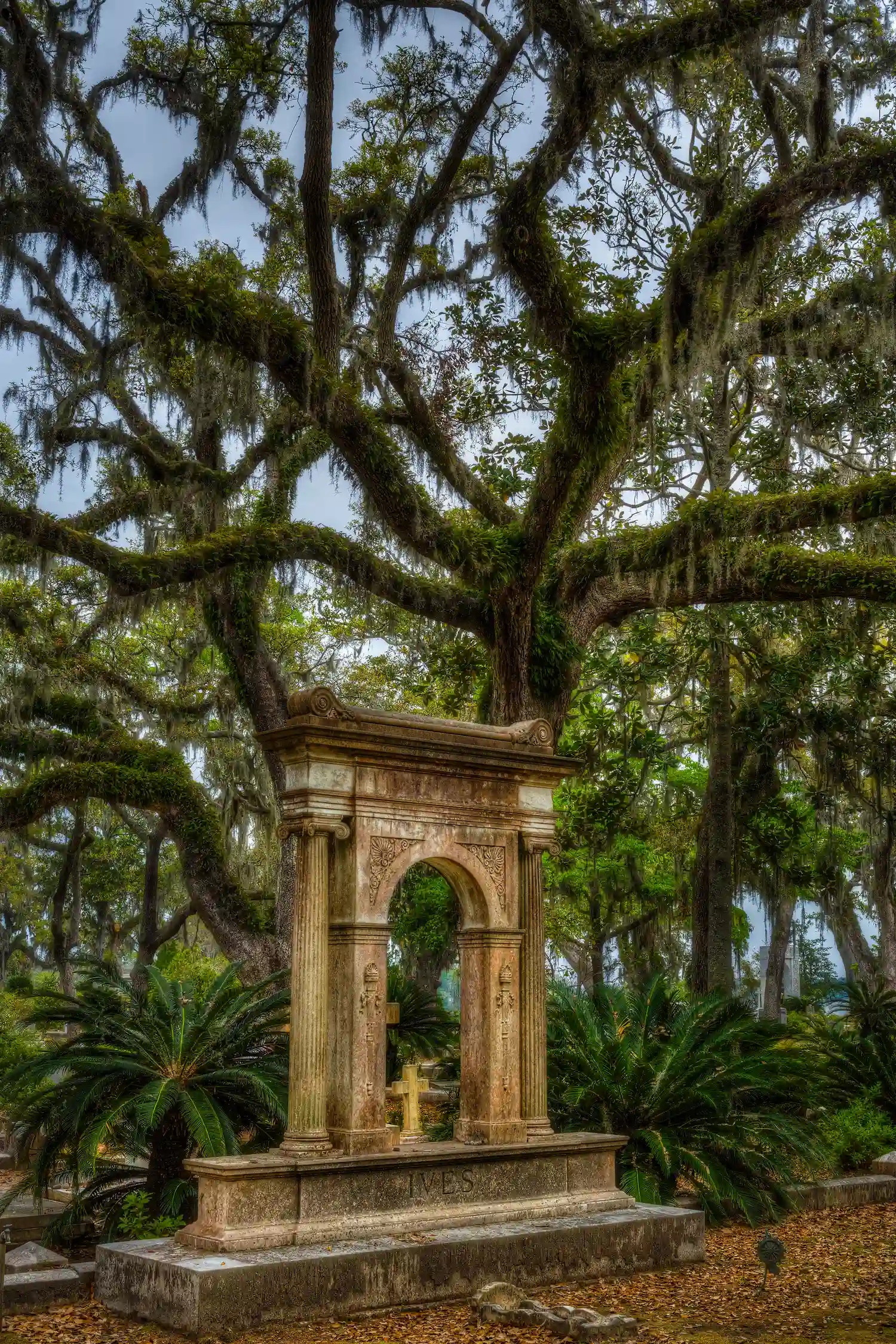 Architectural monument and oak tree at Bonaventure Cemetery in Savannah, Georgia.