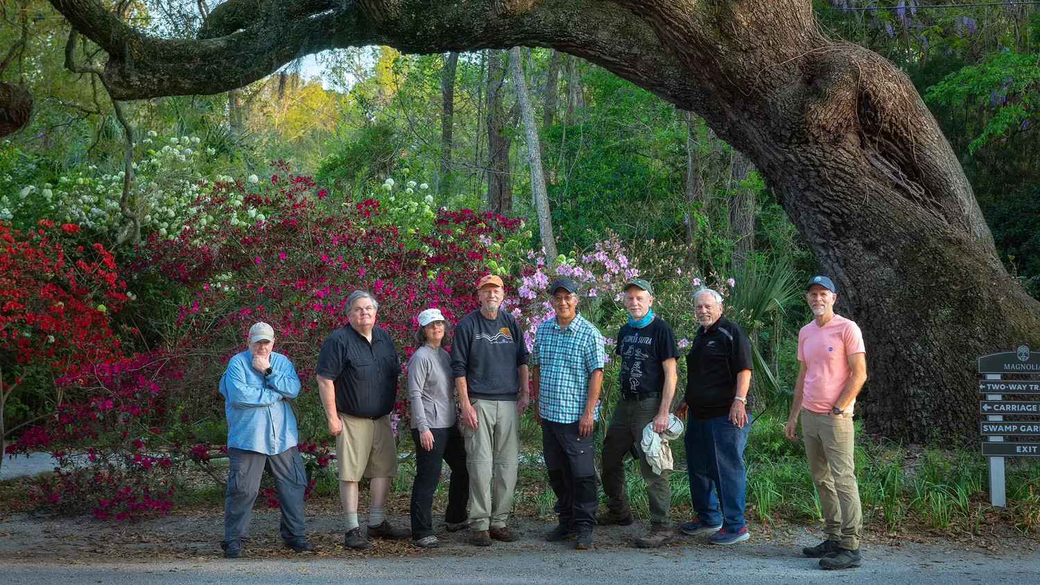 Workshop participants posing together beneath an oak tree with spring blooms at Magnolia Plantation in Charleston.
