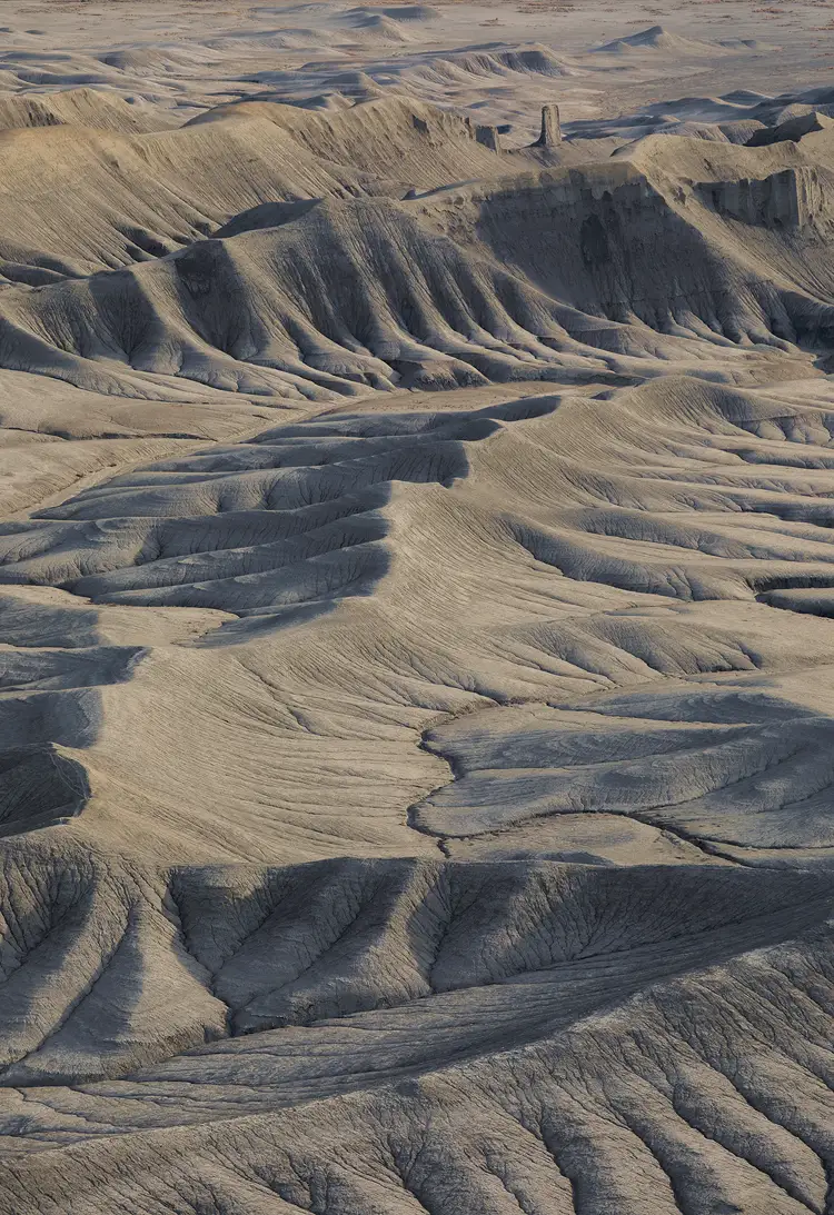 Zig-zagging ridges and ravine-carved slopes at Moonscape Overlook, Utah, softly lit by early morning sidelight.