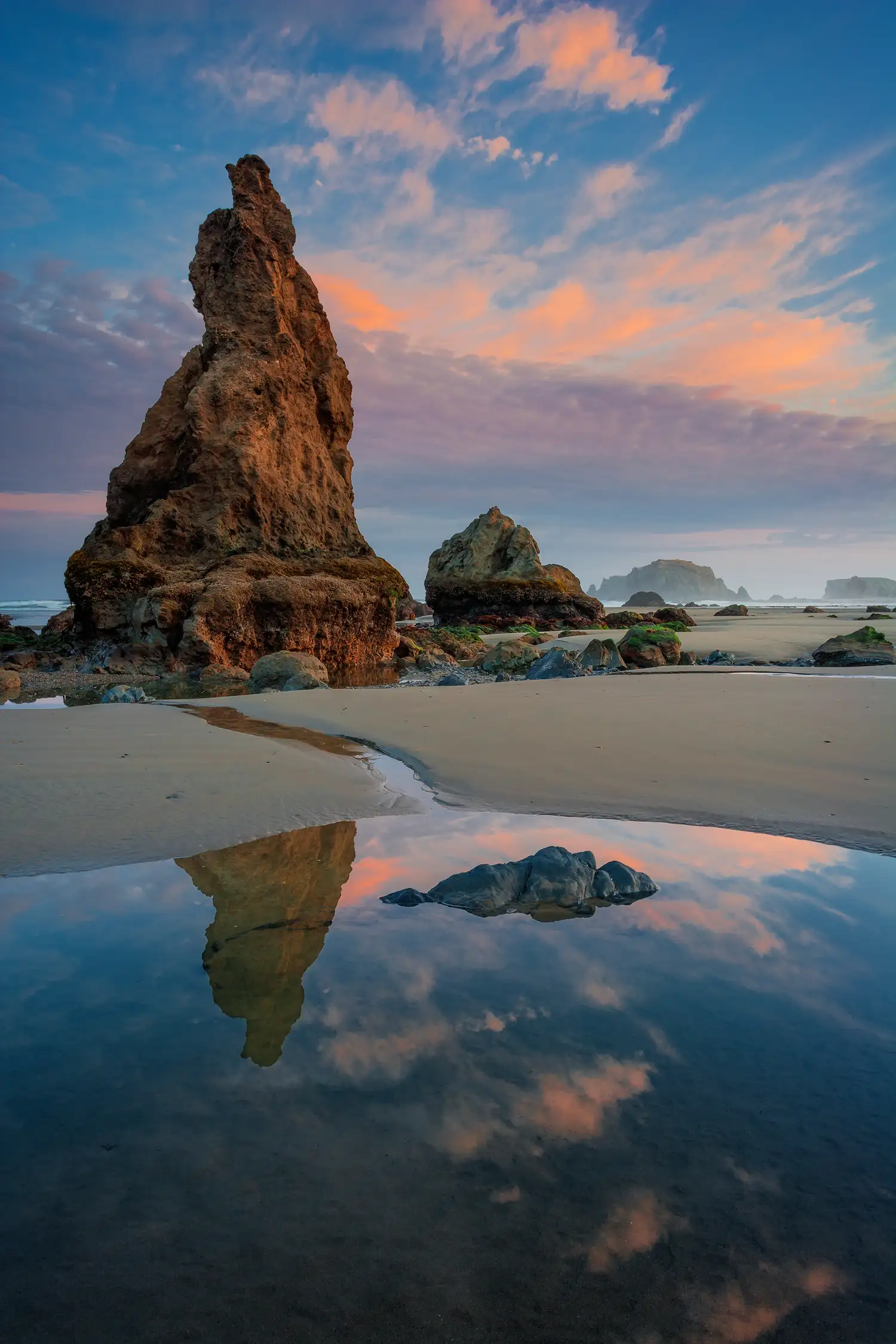 Sea stack reflected in a tide pool at Bandon Beach on the Oregon Coast.
