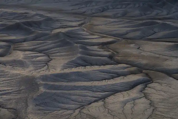 Soft light revealing rolling ridges and intricate erosion patterns at Moonscape Overlook near Hanksville, Utah.