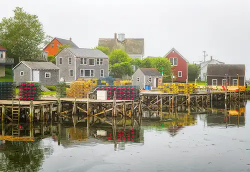 Foggy morning, lobster traps, Maine coast homes. Docks and shacks. Photo by Rick Thompson.