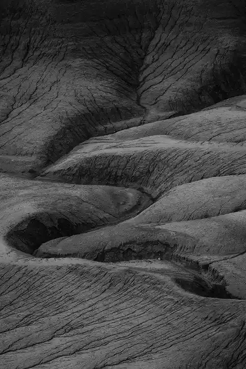 Eroded badlands forming flowing ridges and winding channels at Moonscape Overlook near Hanksville, Utah.