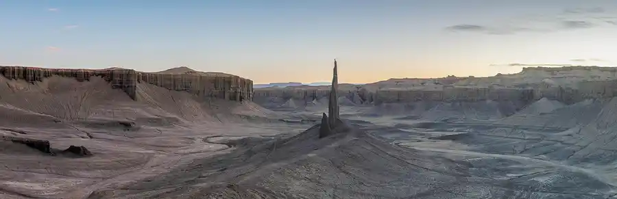 Long Dong Silver standing alone in the quiet badlands after sunset near Hanksville, Utah.