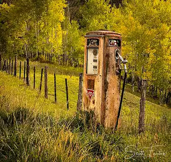 Old gas pump in meadow, autumn aspens in background, Colorado. Photo by Scott Fenton.