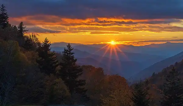 Sunrise starburst, Smoky Mountains, layered mountains, fall colors. Photo by Donna Pyle.