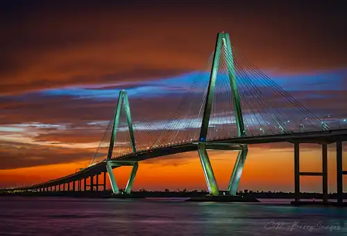 Sunset behind Arthur Ravenel Jr. Bridge, Charleston. Vibrant sky. Photo by Chris Barry.