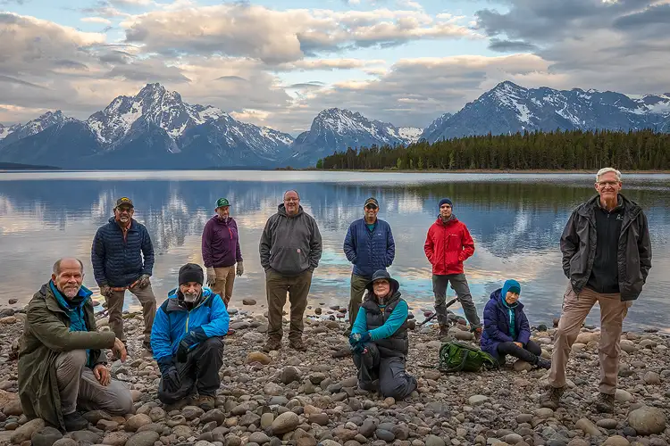 Group photo of participants at Grand Teton National Park Photography Workshop on the shores of Jackson Lake with Mount Moran in the background.
